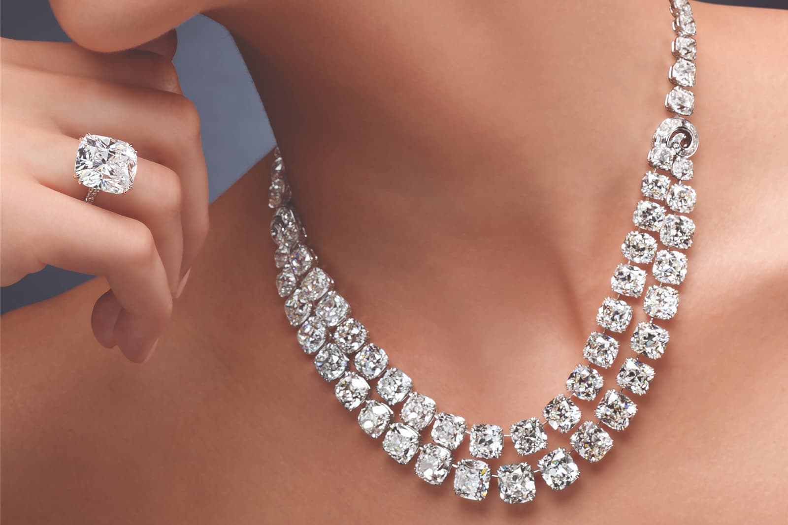 Ronald Abram double row diamond necklace with 119.03 carats of antique cushion-cut diamonds alongside a 14.28 carat cushion-cut diamond ring
