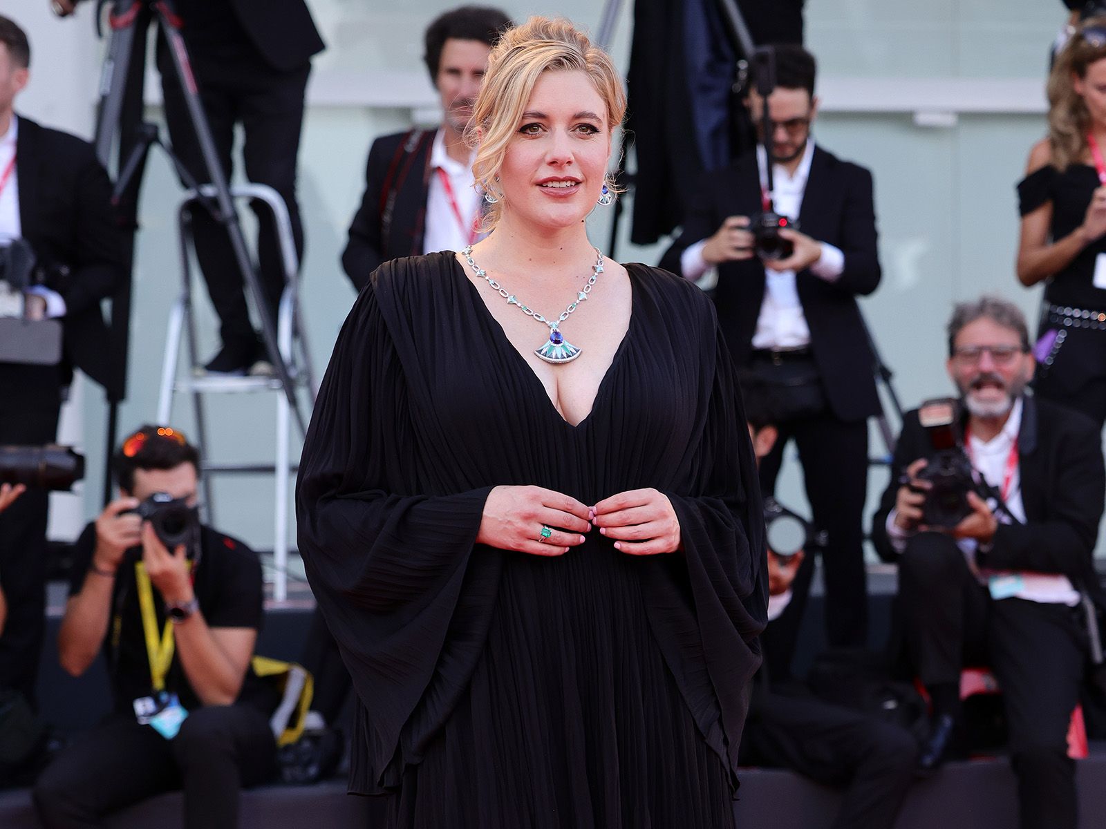 Actress and director Greta Gerwig wears a Bulgari Diva’s Dream High Jewellery set with mother of pearl, turquoise, chrysoprase and a 27.77 carat tanzanite at the 2022 Venice International Film Festival