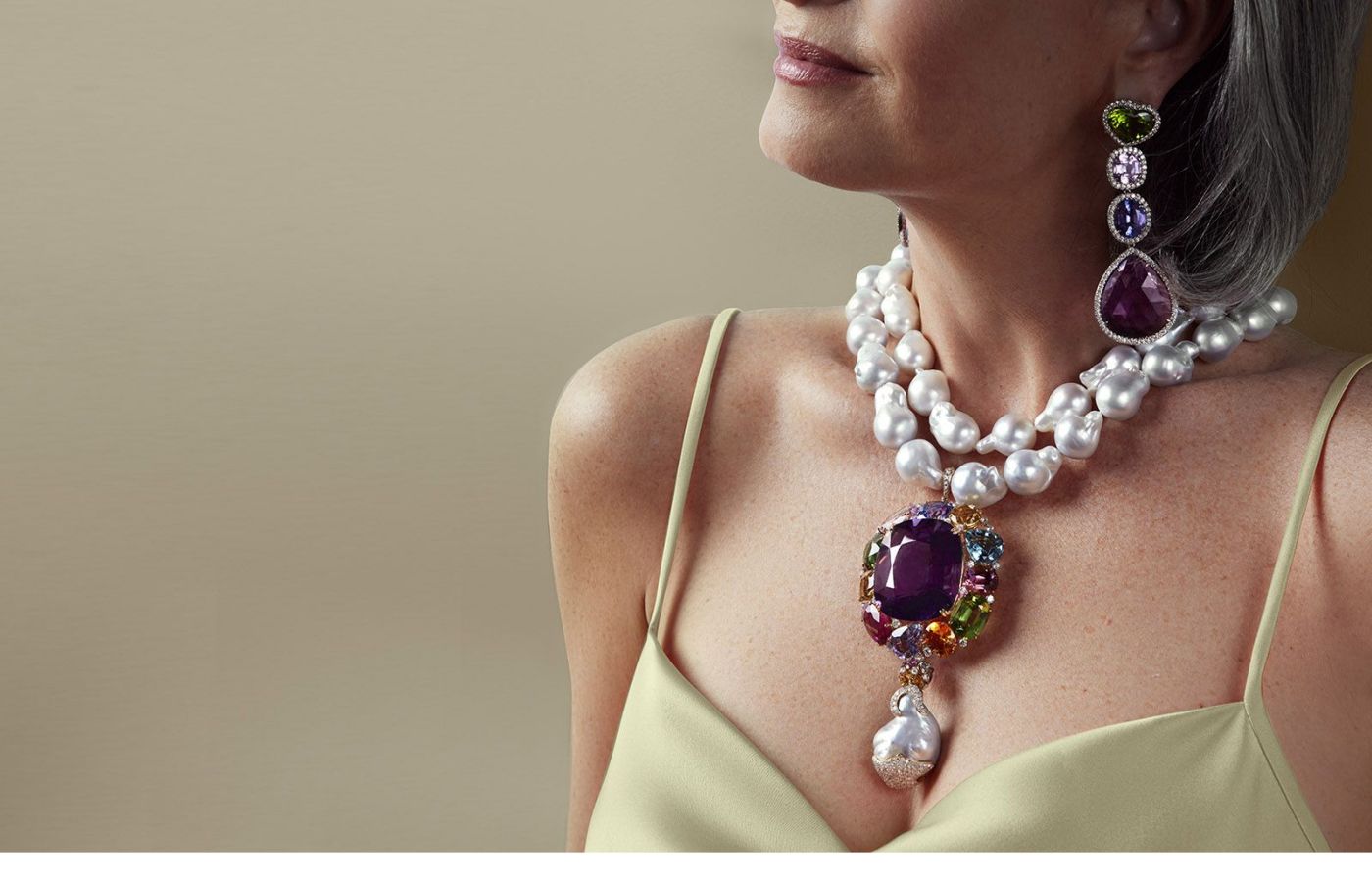 Model wearing Margot McKinney High Jewellery necklace in coloured gemstones and pearls