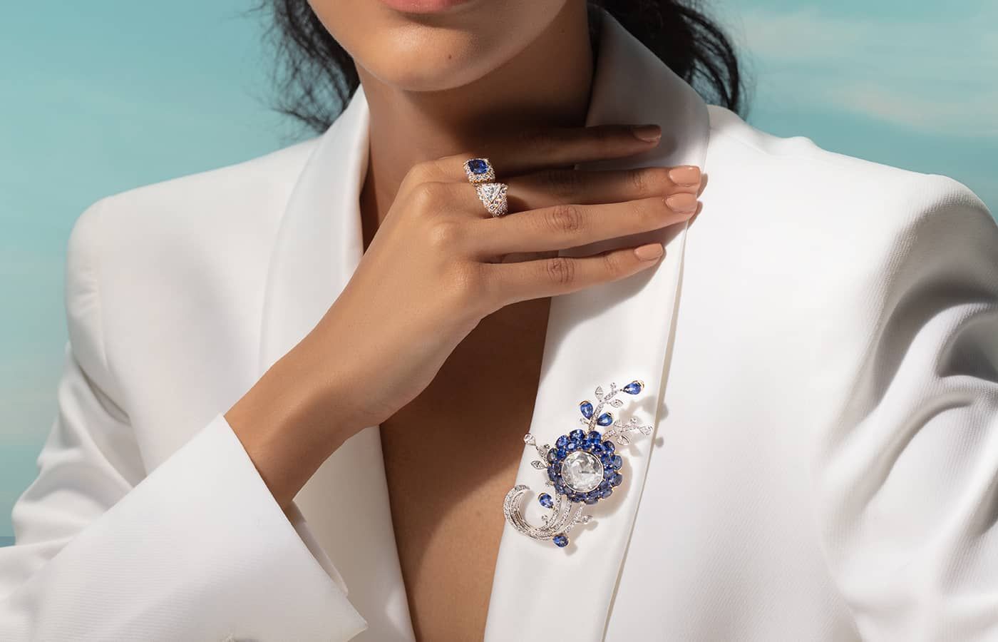 Model wearing Alok Lodha sapphire and diamond ring and brooch