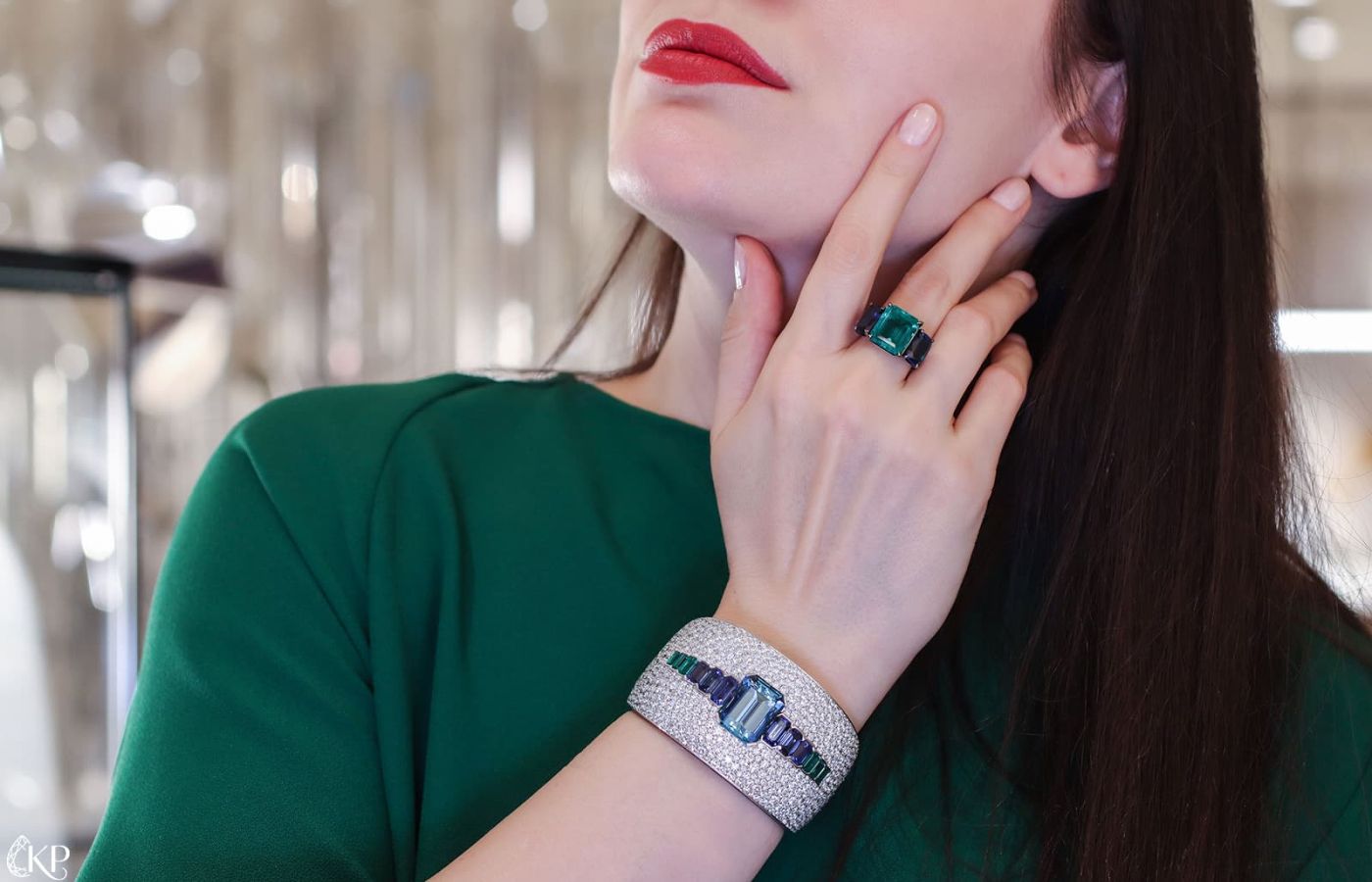 Katerina Perez wearing Bucherer High Jewellery aquamarine, sapphire and diamond cuff with an emerald ring