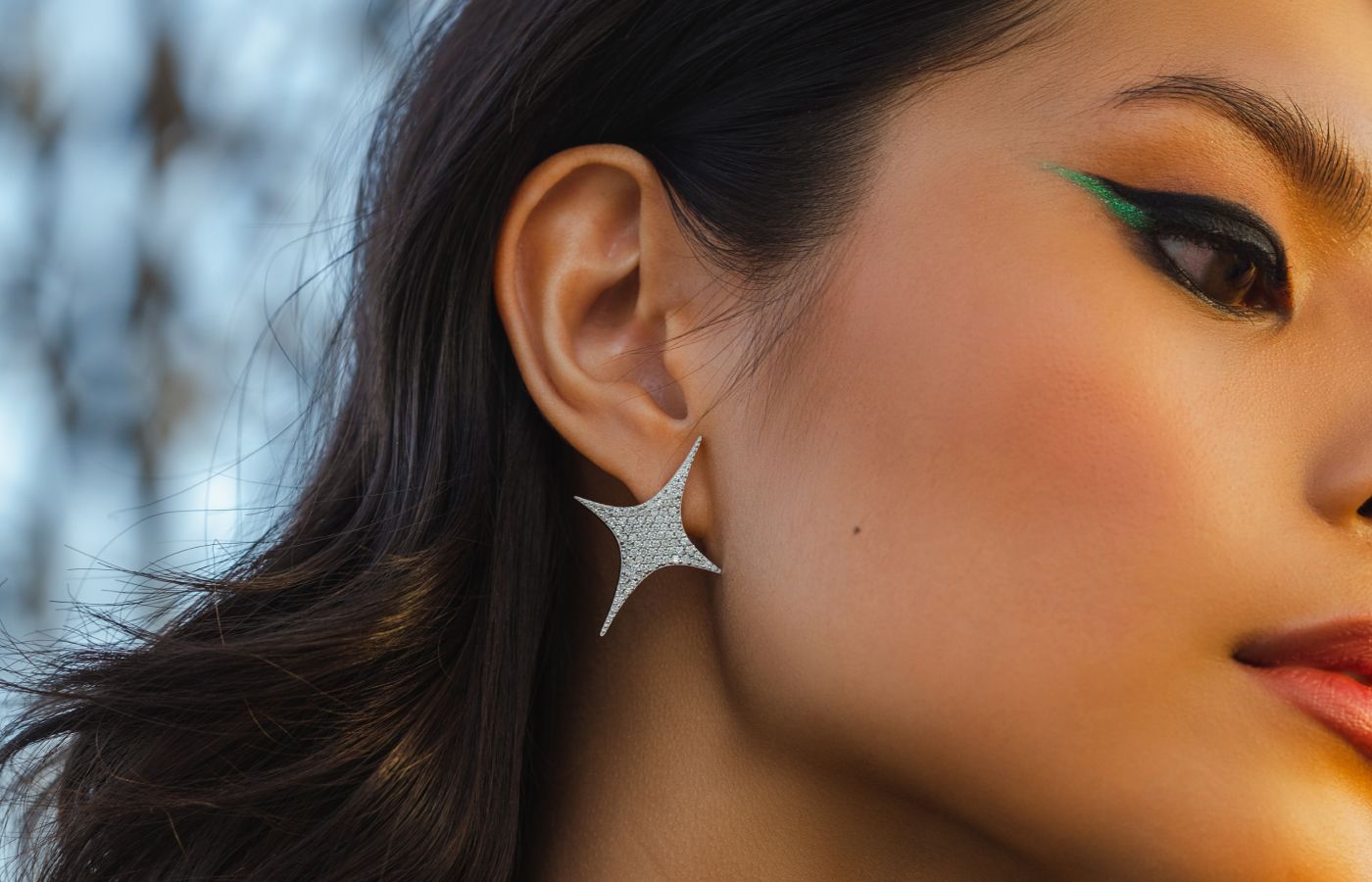  A model wears the Signature Sparkle diamond earrings by TOi